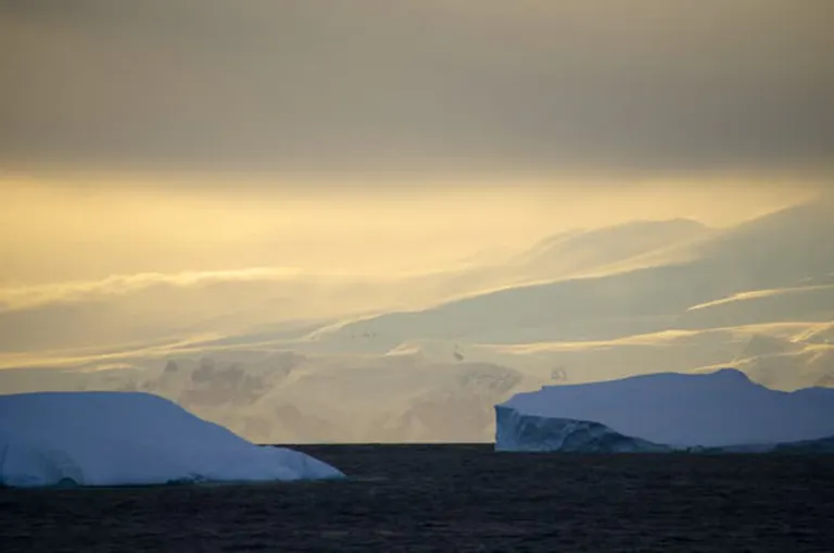 the sun peeking under clouds in Antarctica