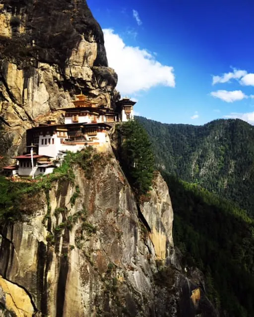 A monastery on the side of a cliff in bhutan.