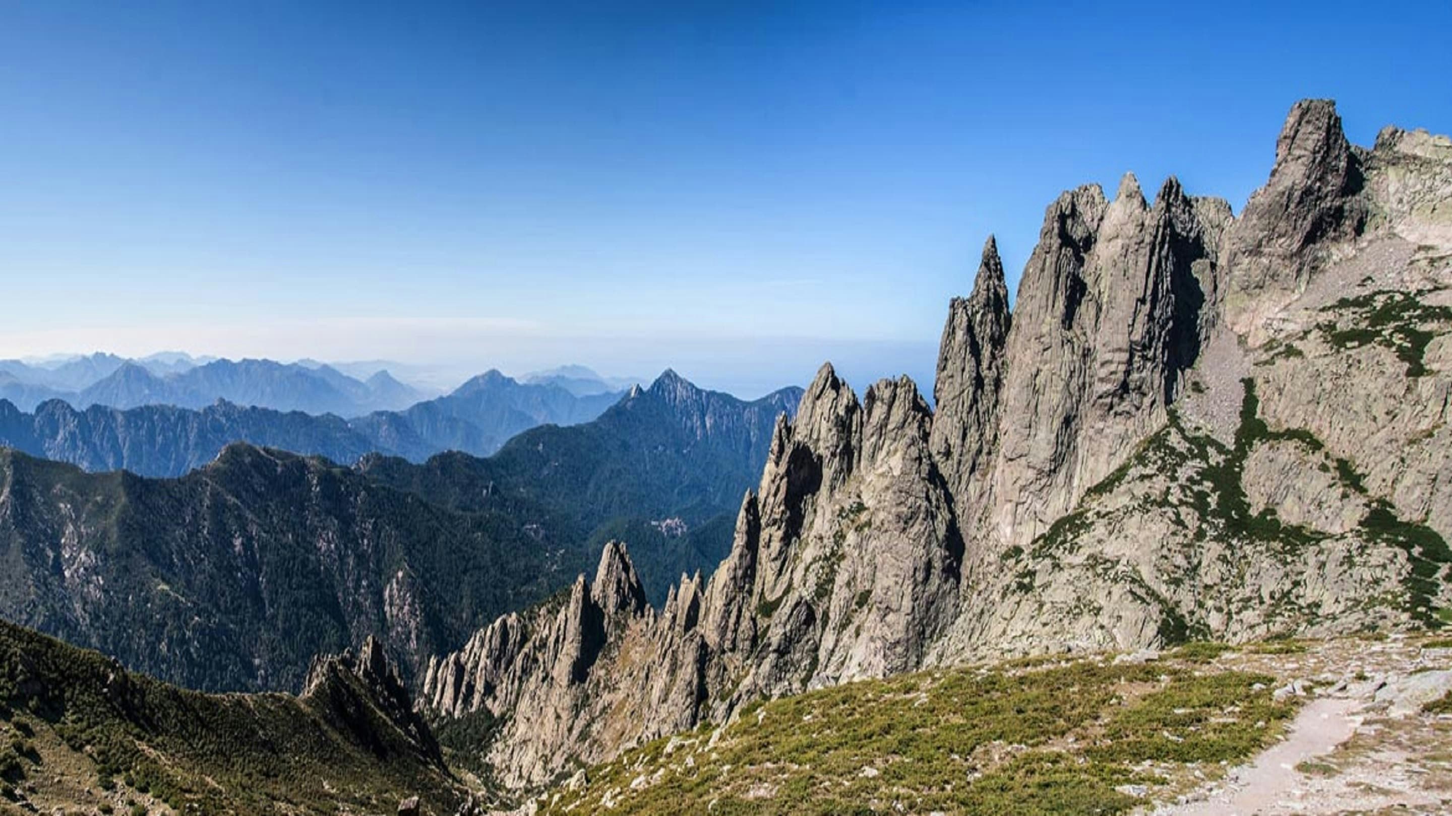 A view of mountains from the top of a mountain.