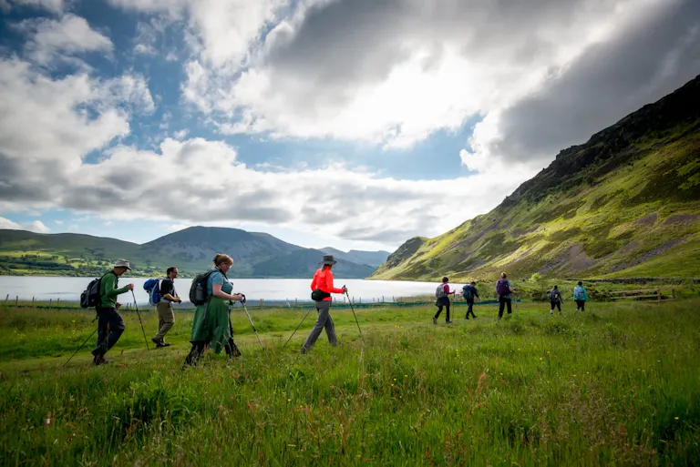 group of travelers trekking poles on the grassy plains of the England Coast to Coast trail, a classic MT Sobek active adventure