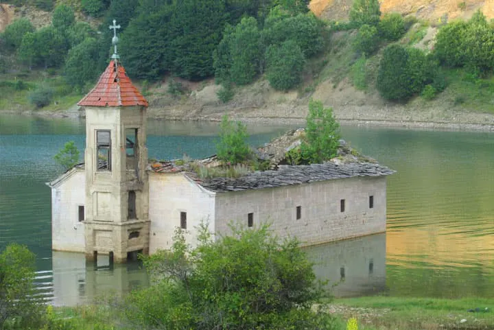 An old church in the middle of a lake.