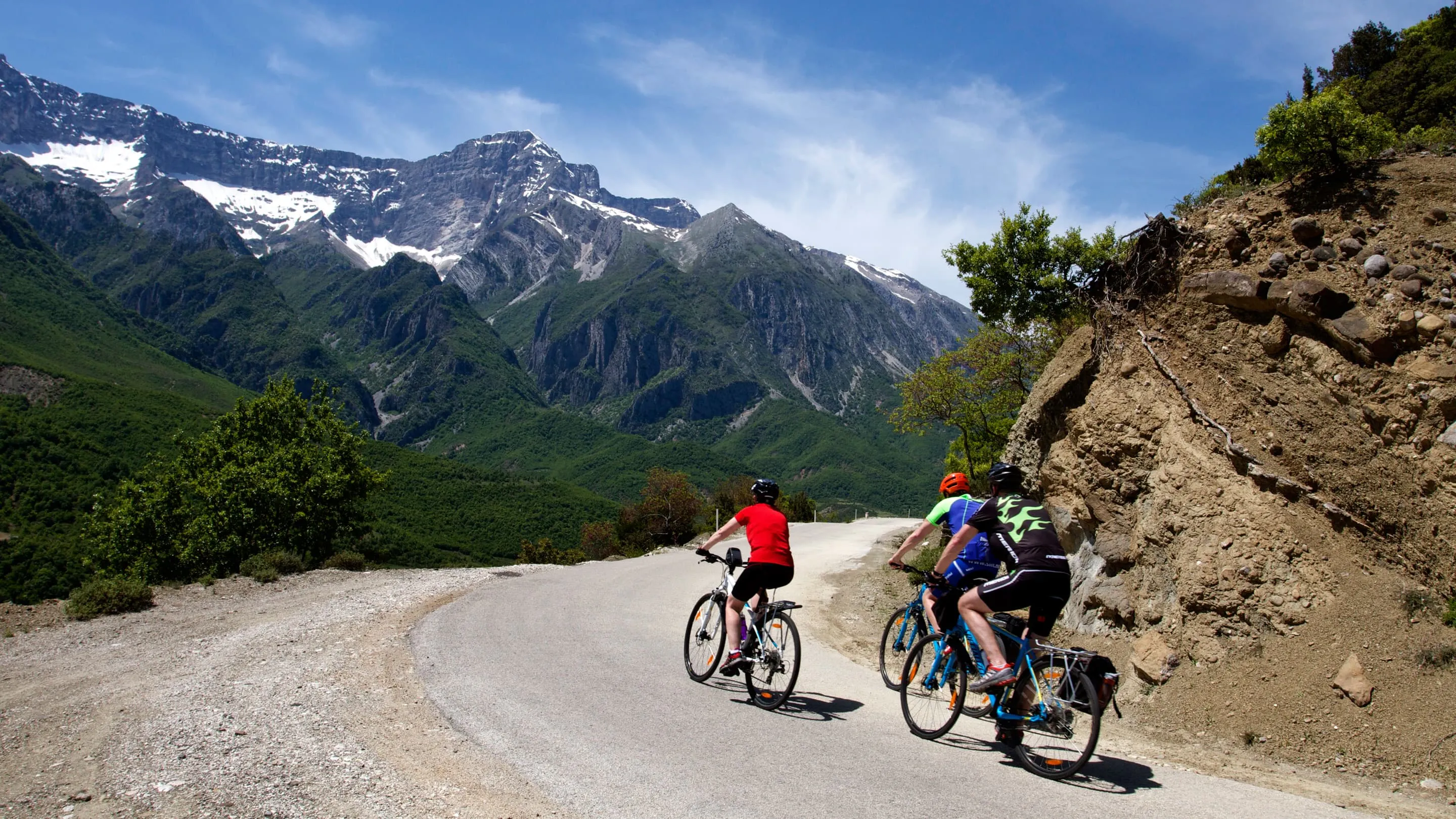 A group of people riding bikes down a mountain road.