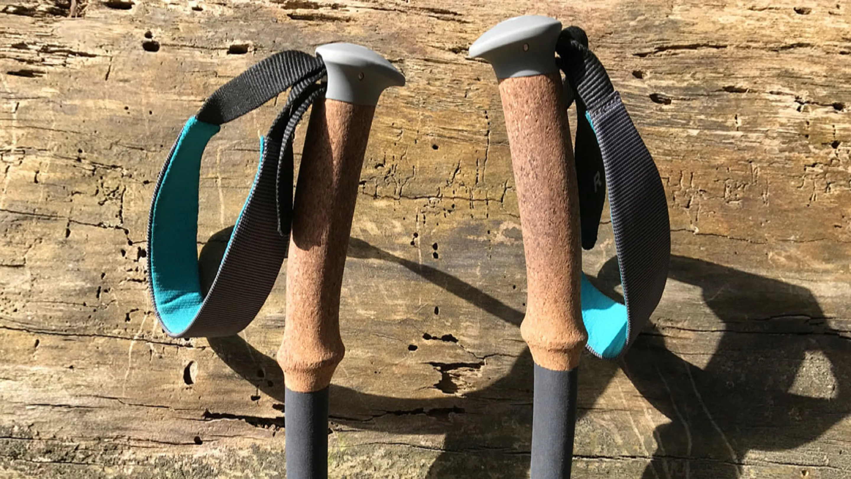 Two hiking poles on a wooden surface.