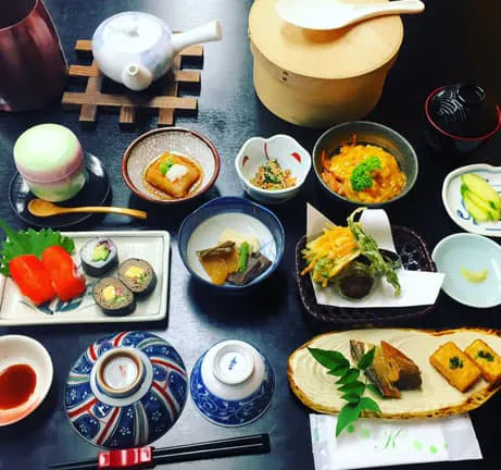 A table full of japanese food on a table.