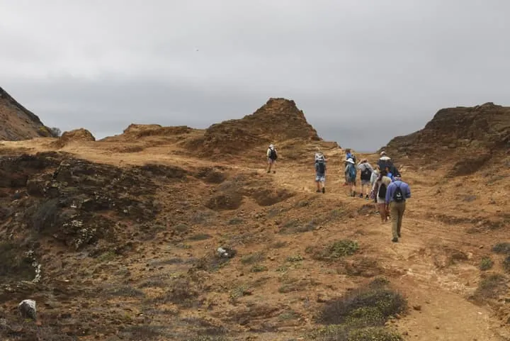A group of people hiking on a rocky trail.