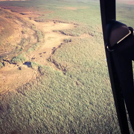 A view from the cockpit of a plane with a river in the background.