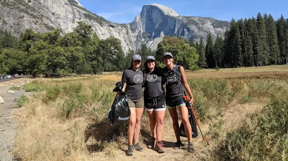 Three women standing in front of yosemite mountain.