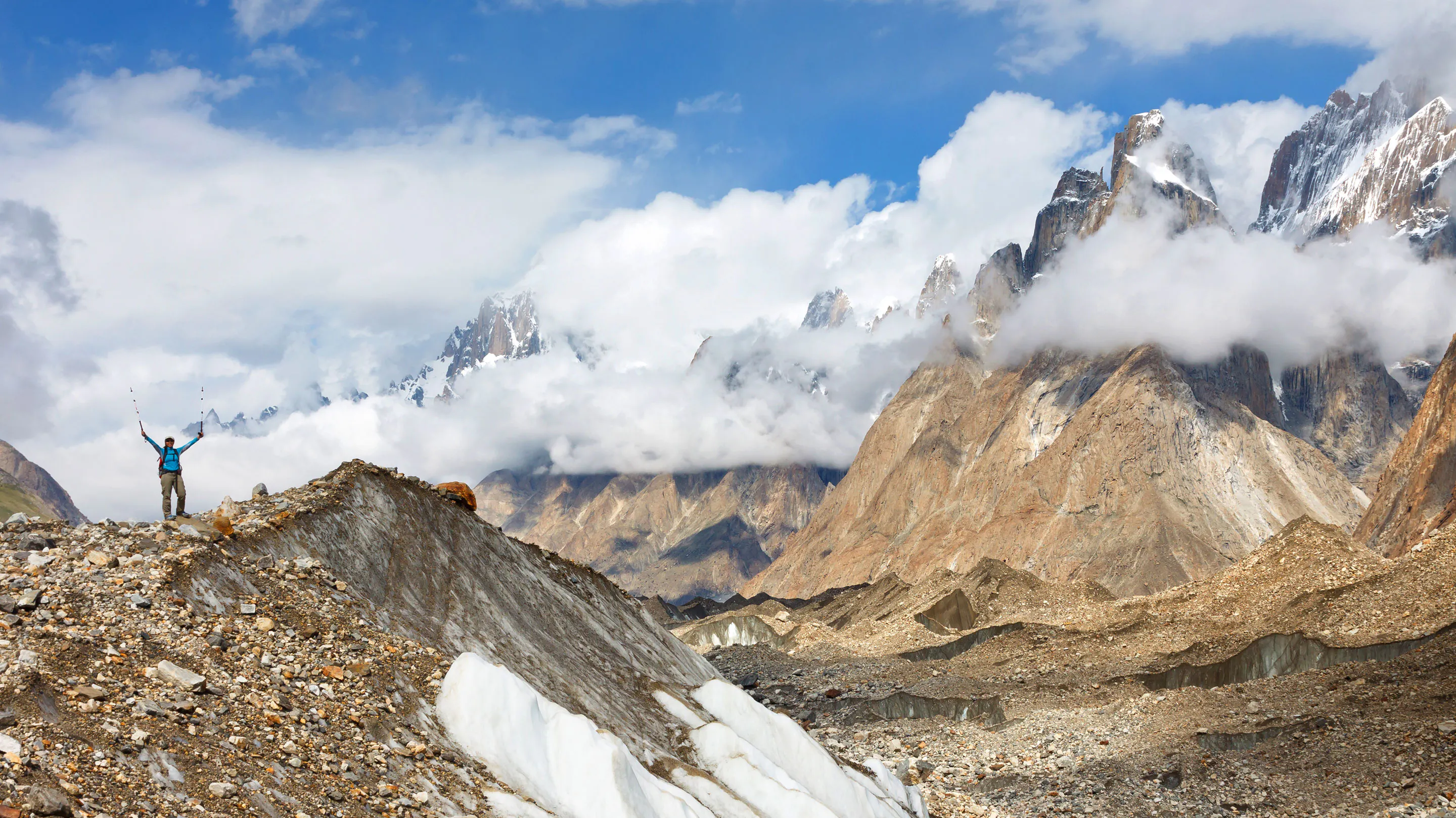 A man standing on top of a mountain in pakistan.