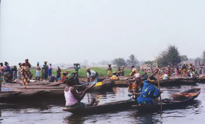A group of people in boats on a river.