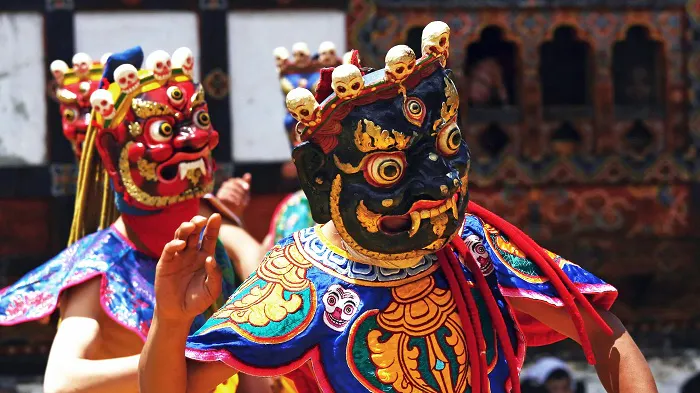 A group of people wearing colorful masks in bhutan.