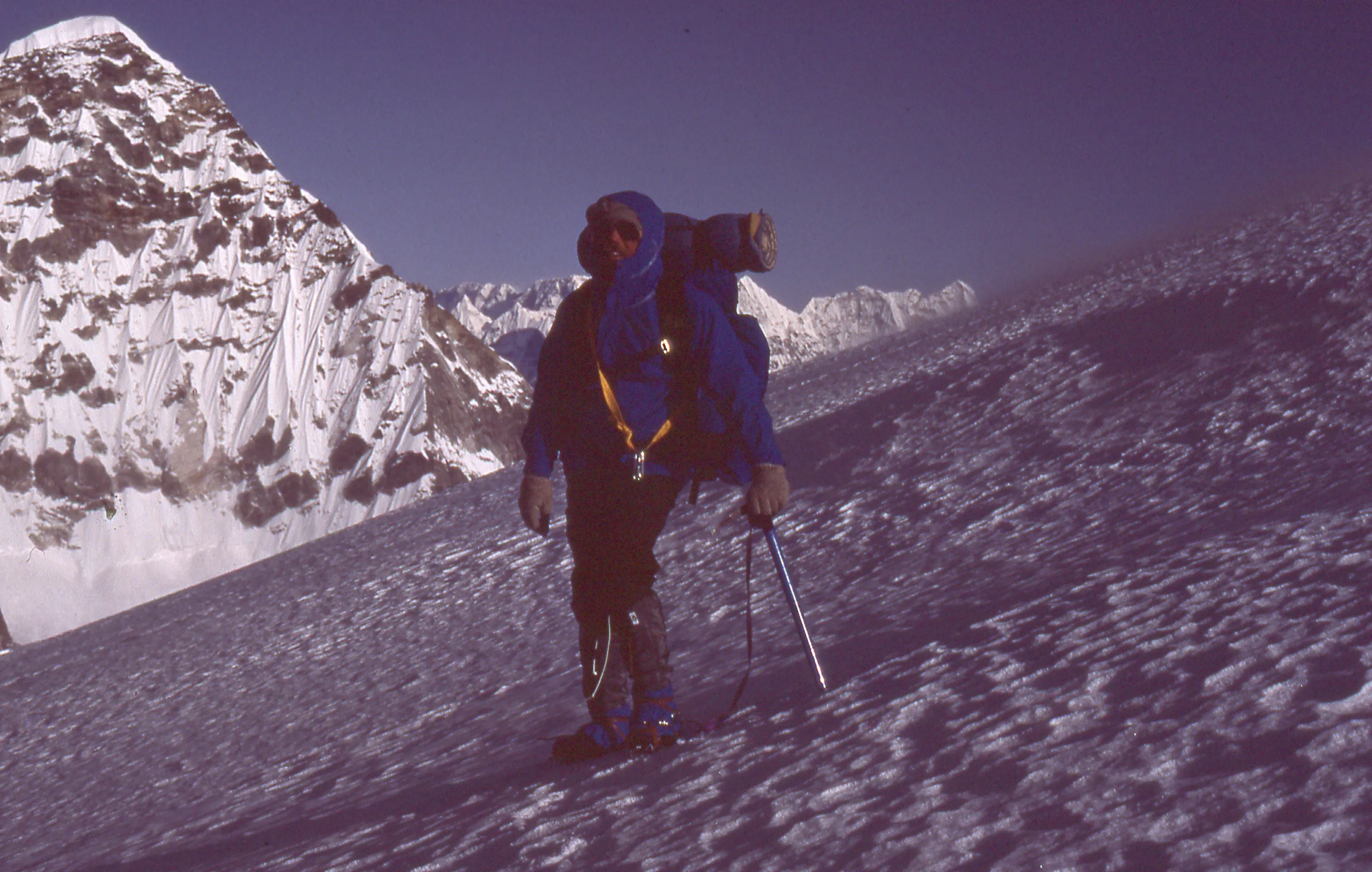 A person standing on top of a snow covered mountain.