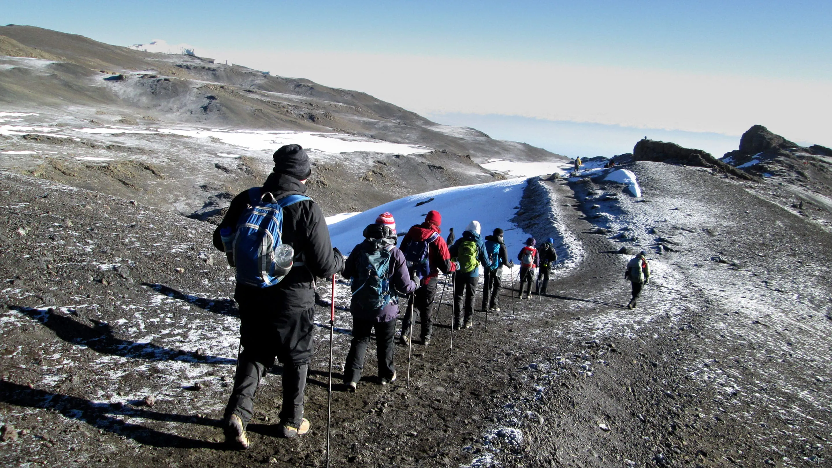 A group of people hiking up a mountain.