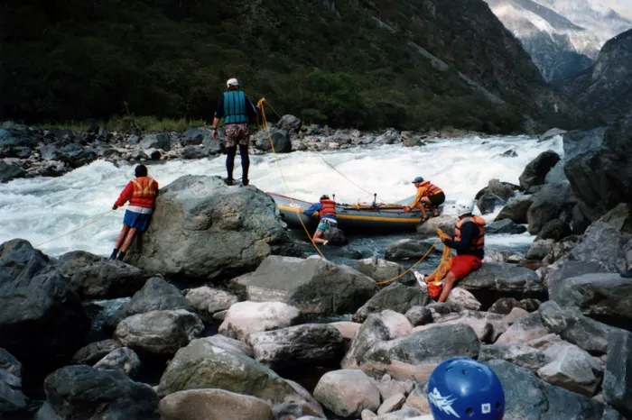 A group of people rafting down a river.