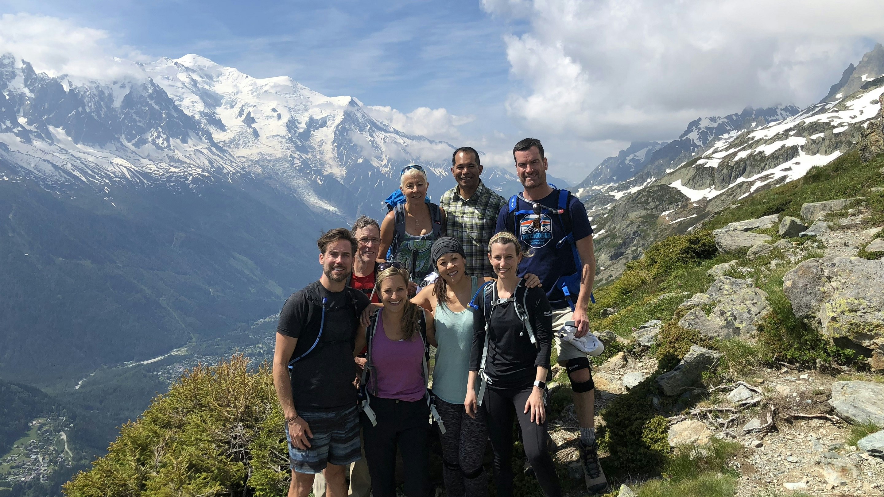 A group of people posing for a photo on a mountain.