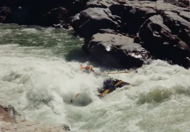 A group of people rafting down a river.