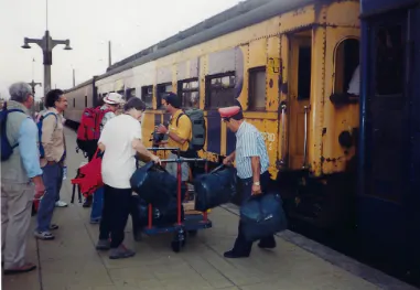 A group of people standing next to a train.