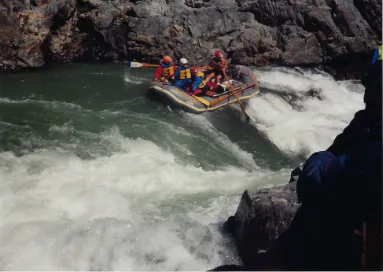 A group of people rafting down a river.