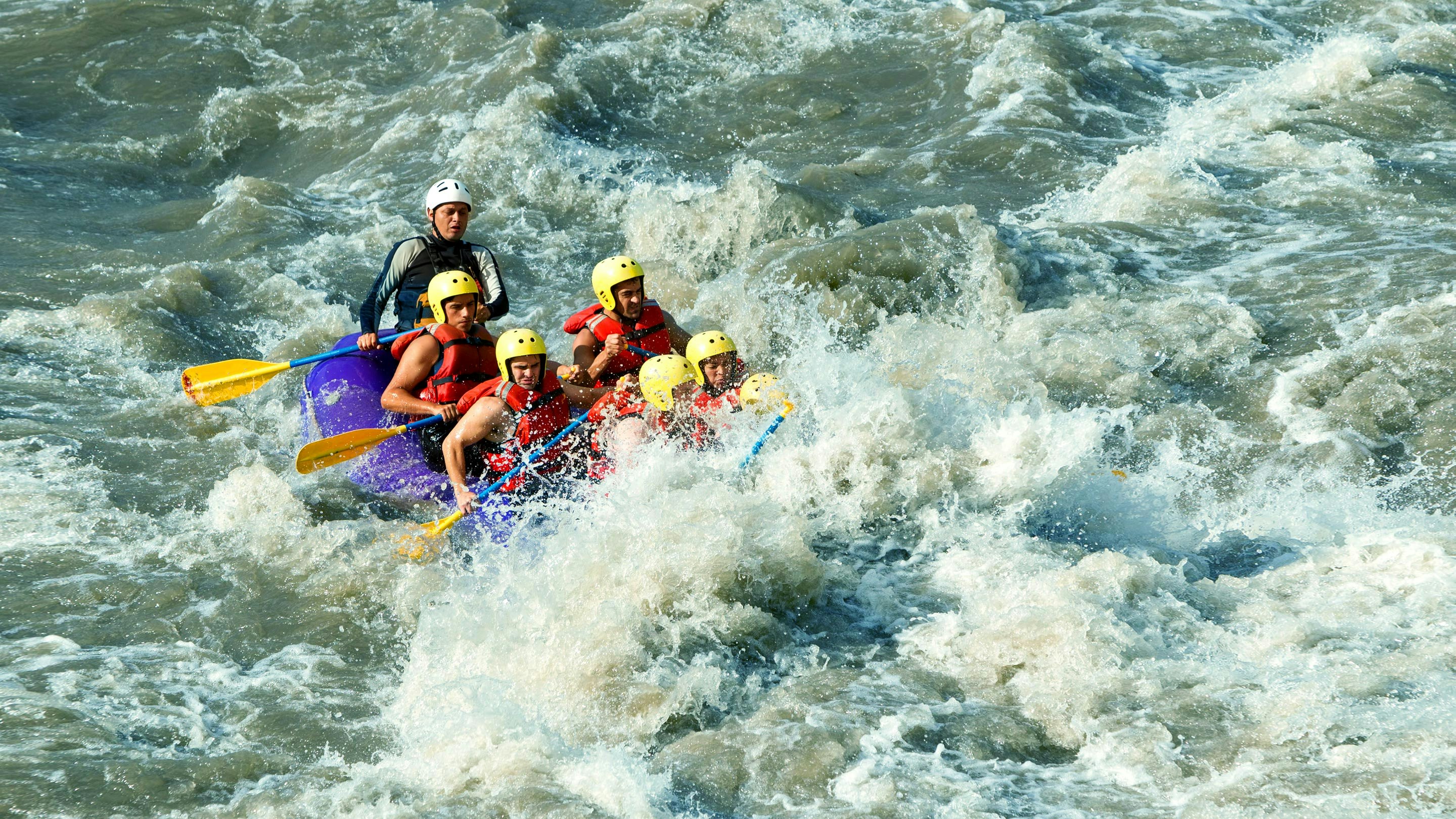 A group of people rafting down a river.