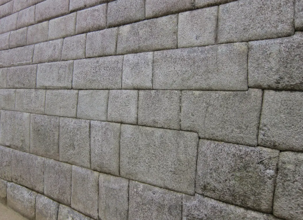 A stone wall with a lot of stones on it.
