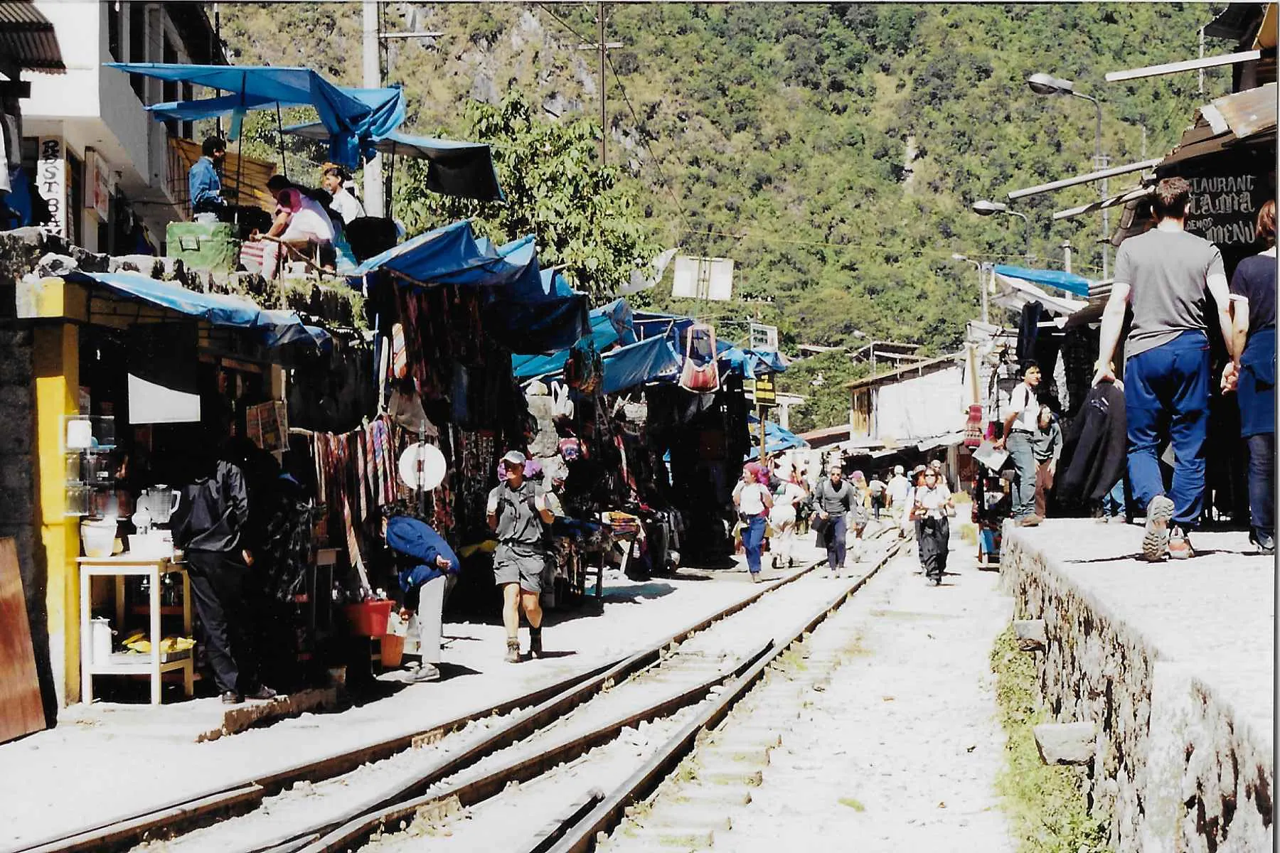 A train track with people walking on it.
