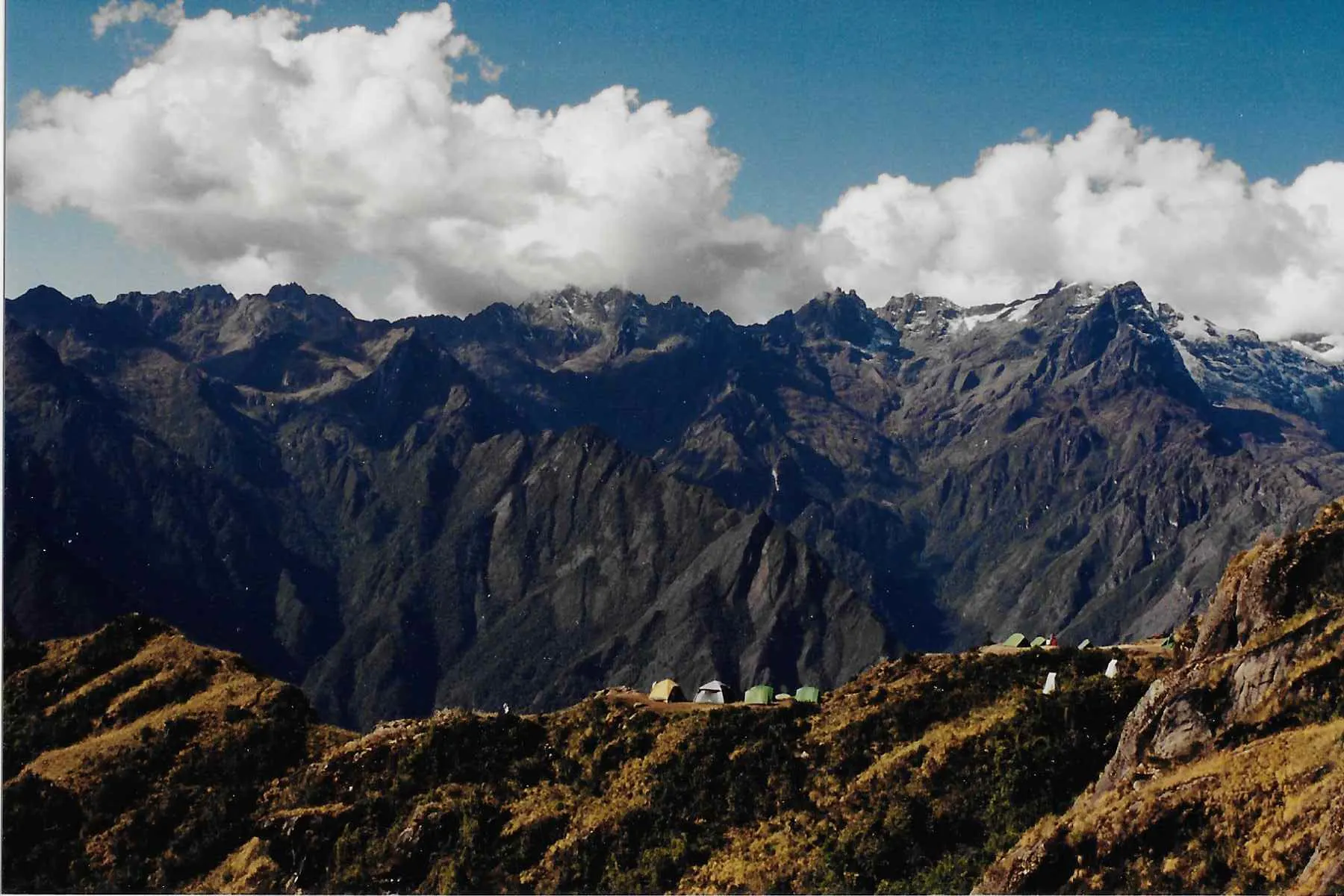 A mountain range with mountains and clouds in the background.