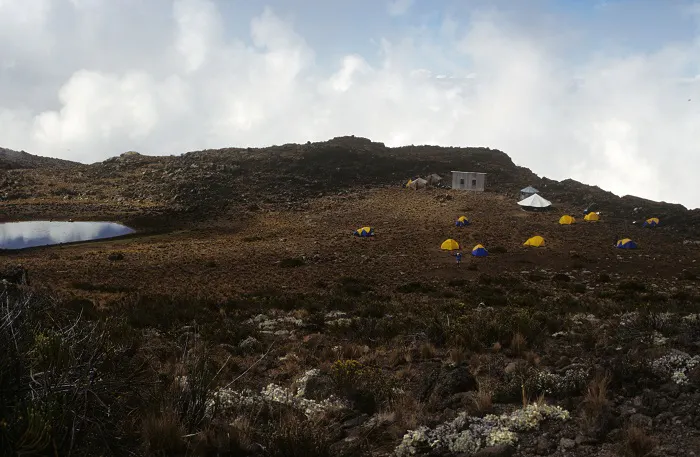 A group of tents on top of a mountain.