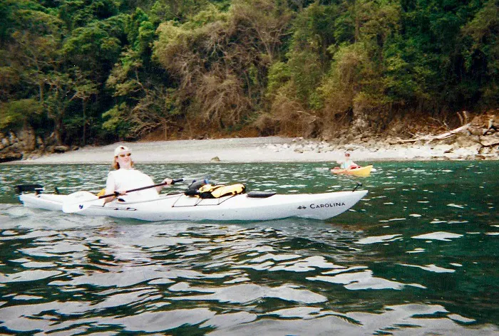 A person is paddling a kayak in a body of water.