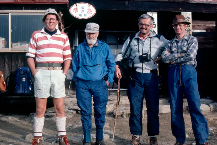 Four men standing in front of a building.