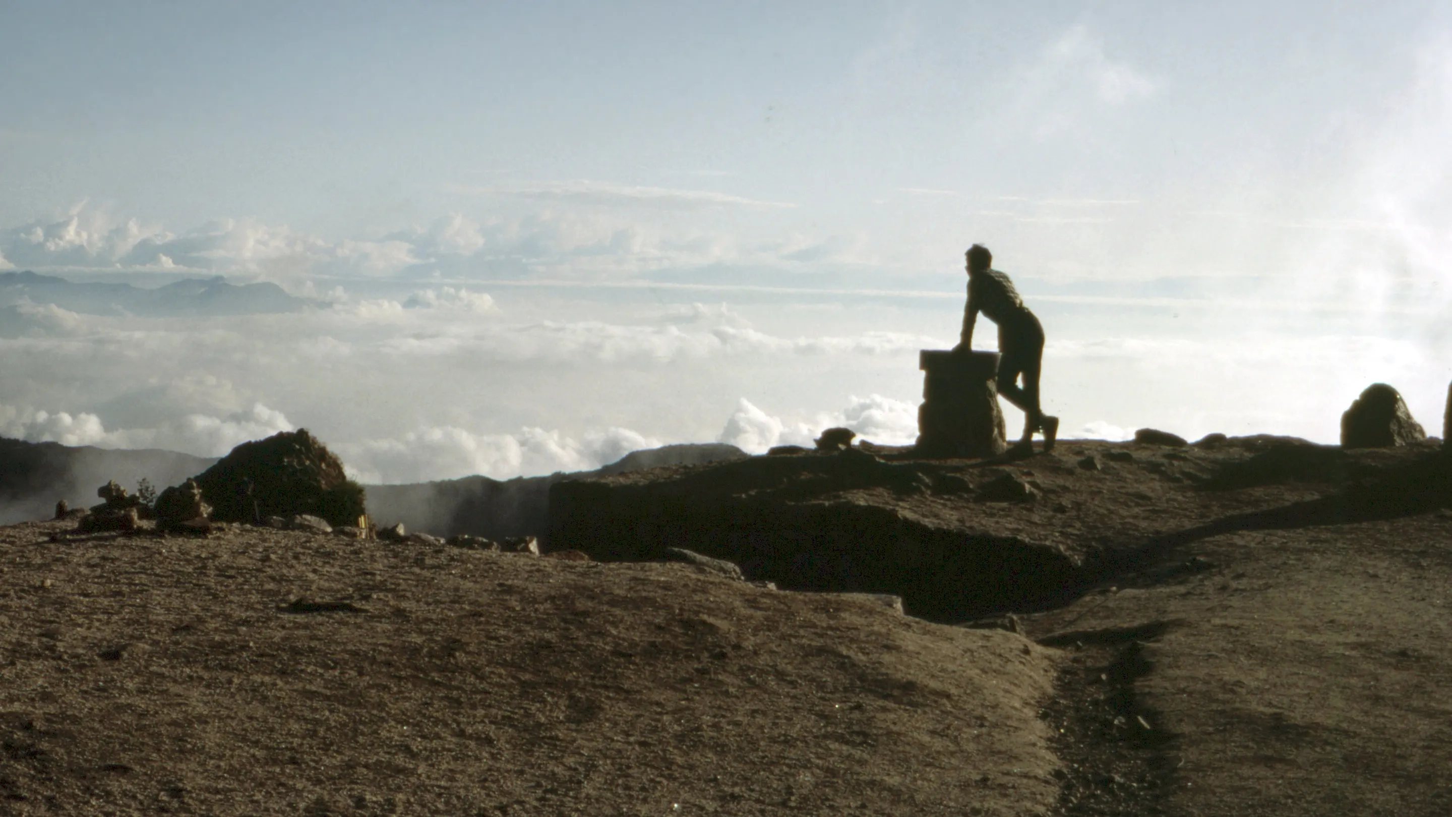 A person standing on top of a mountain.