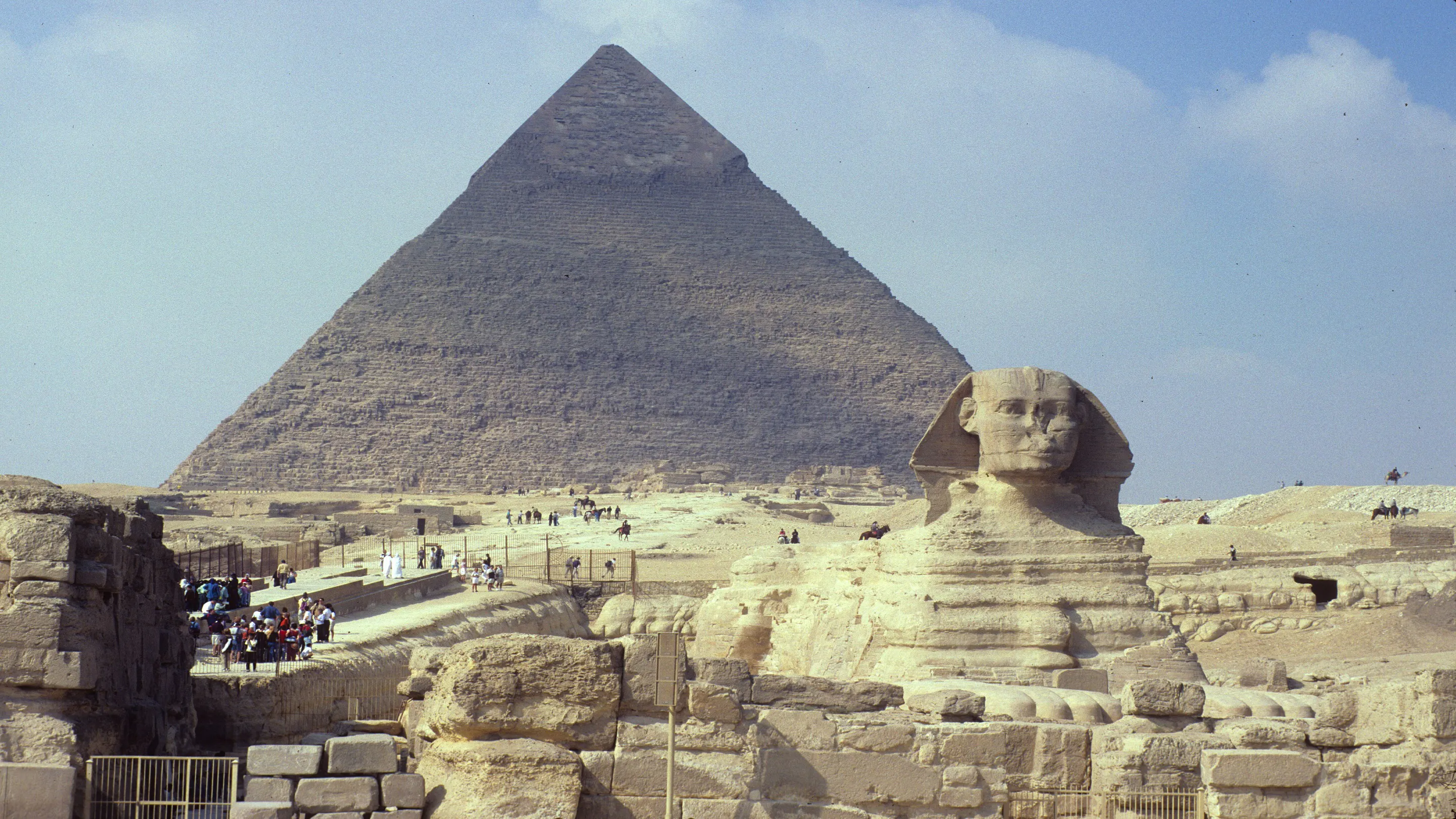 A sphinx in front of a pyramid.