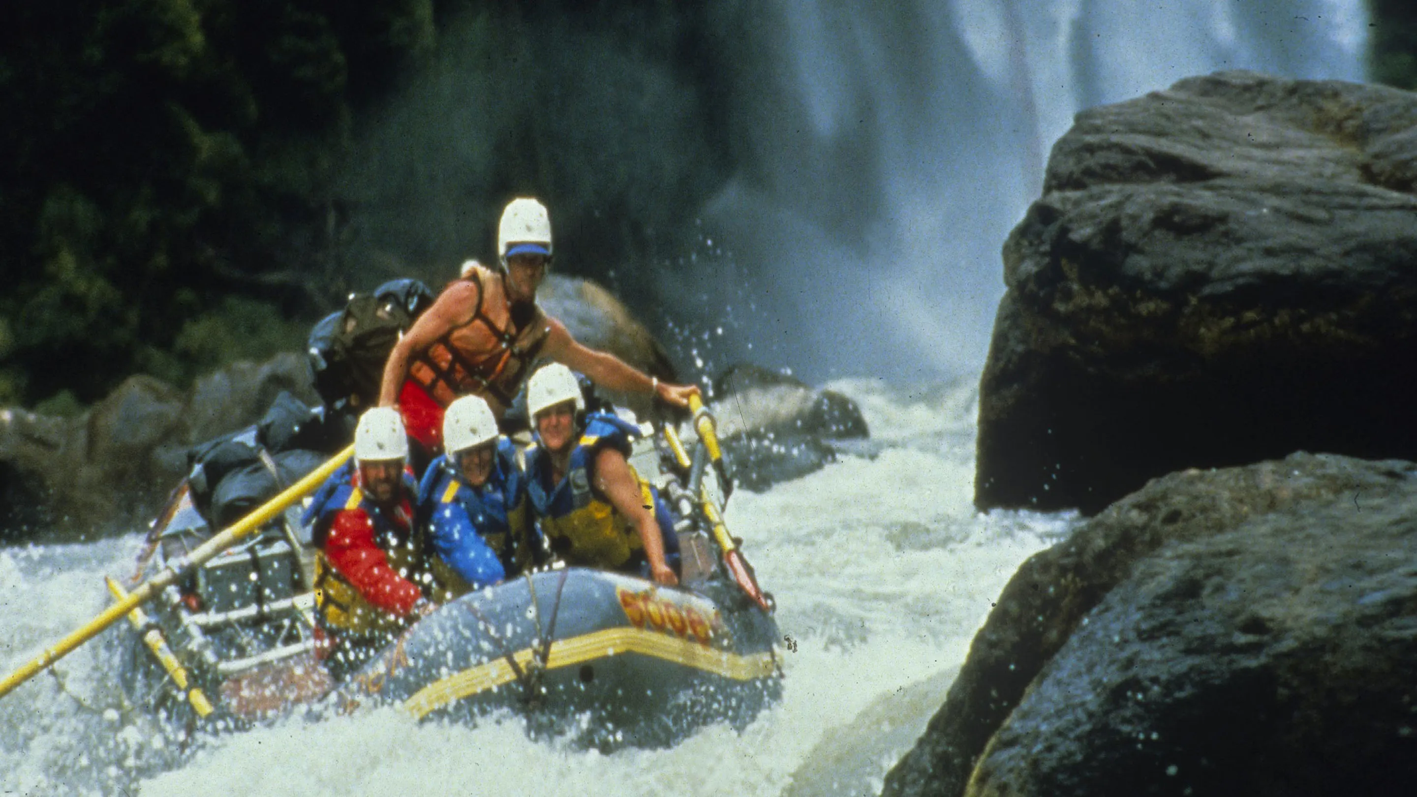 A group of people rafting down a river.