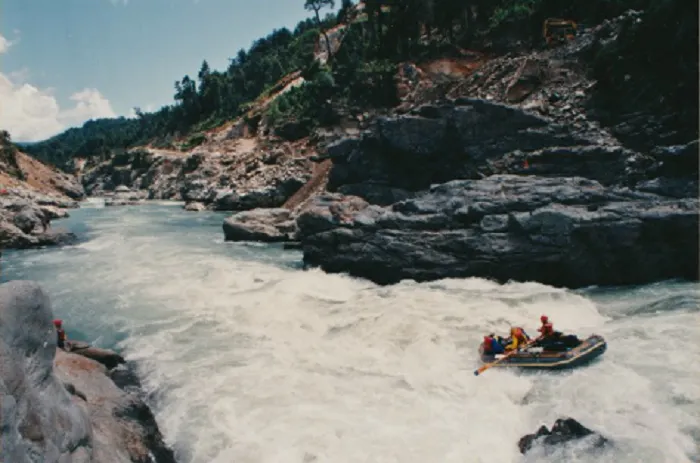 A group of people rafting down a river.