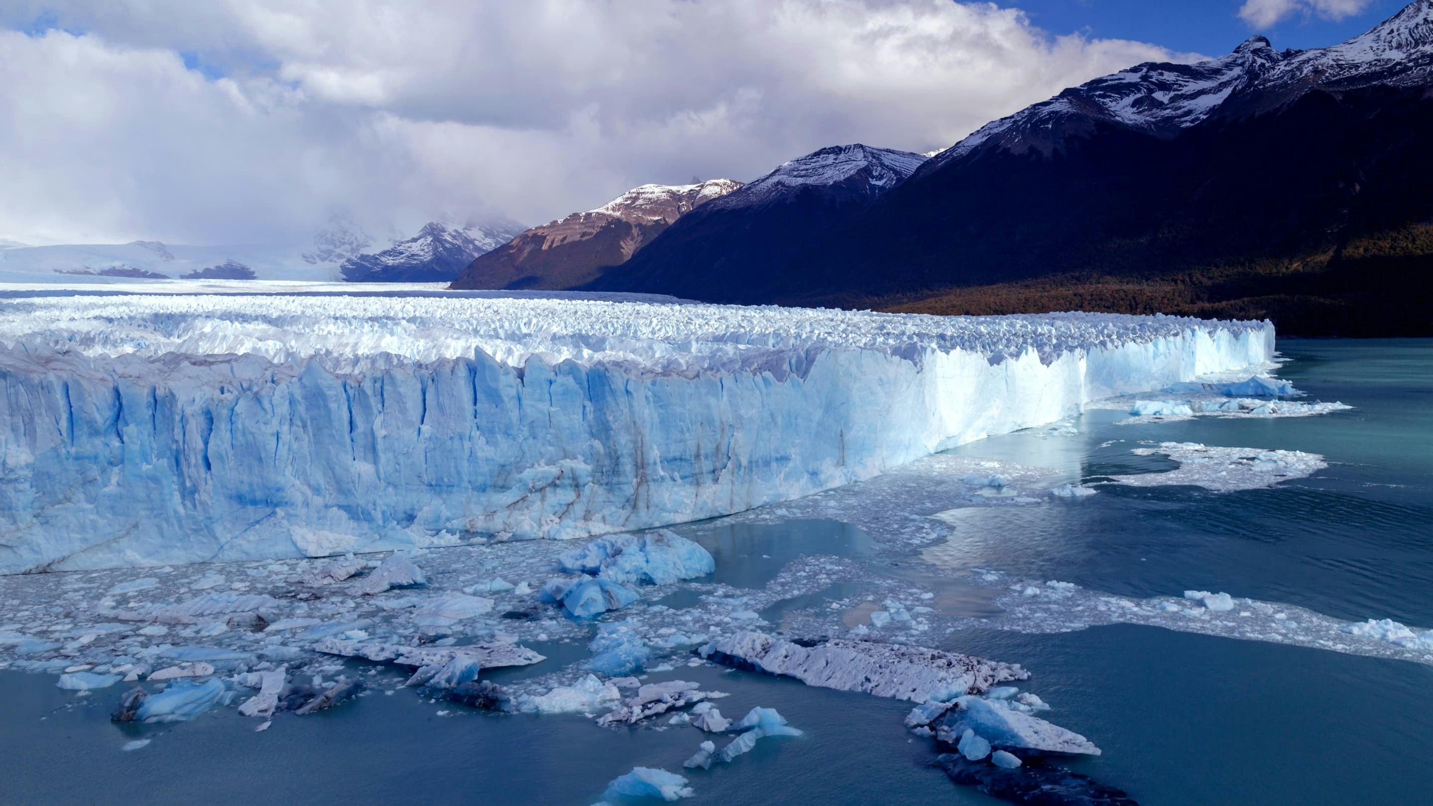 A glacier with ice floating in the water.