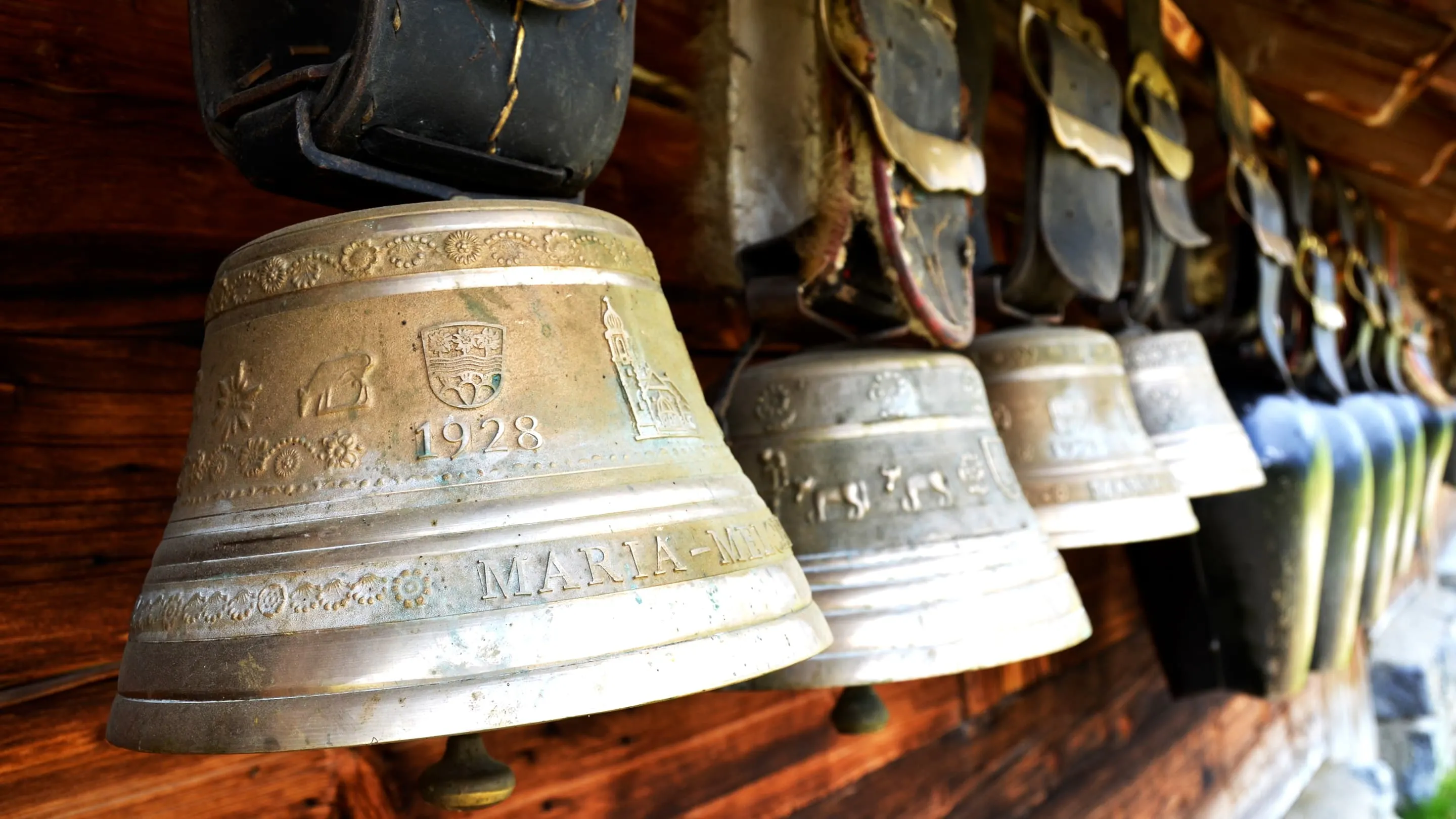 Bells hanging on a wooden wall.