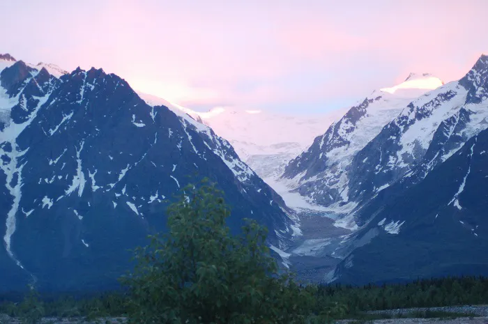 A mountain range is seen at dusk.