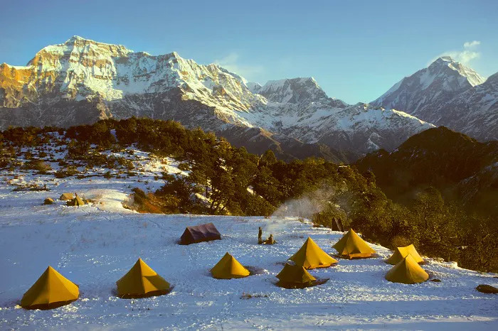 A group of tents set up on a snowy mountain.