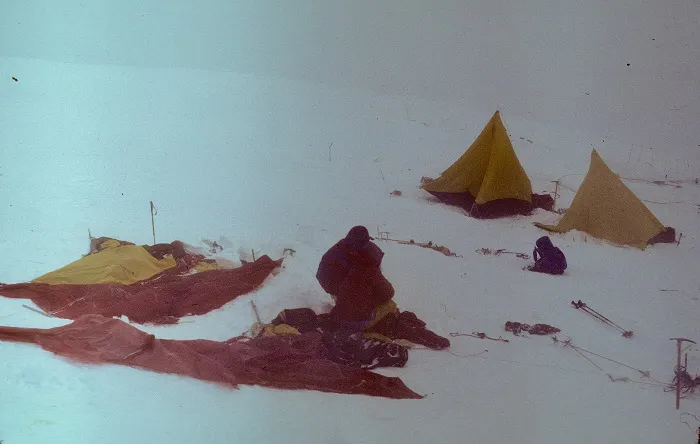 Tents and tents on a snowy slope.