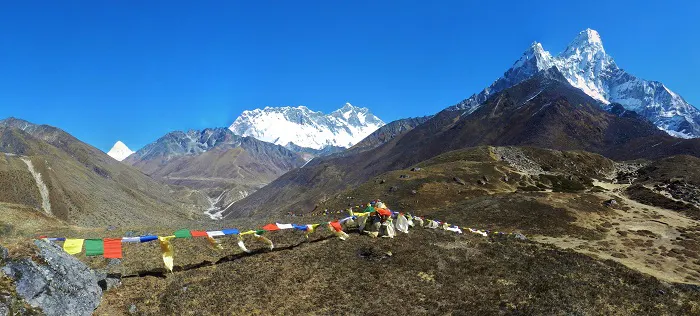 A view of the mountains with prayer flags in the background.