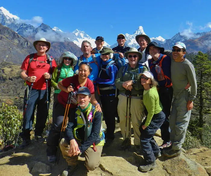 A group of people posing for a photo on a mountain.