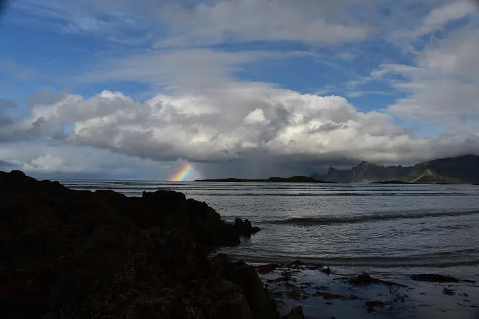 A rainbow over a body of water.
