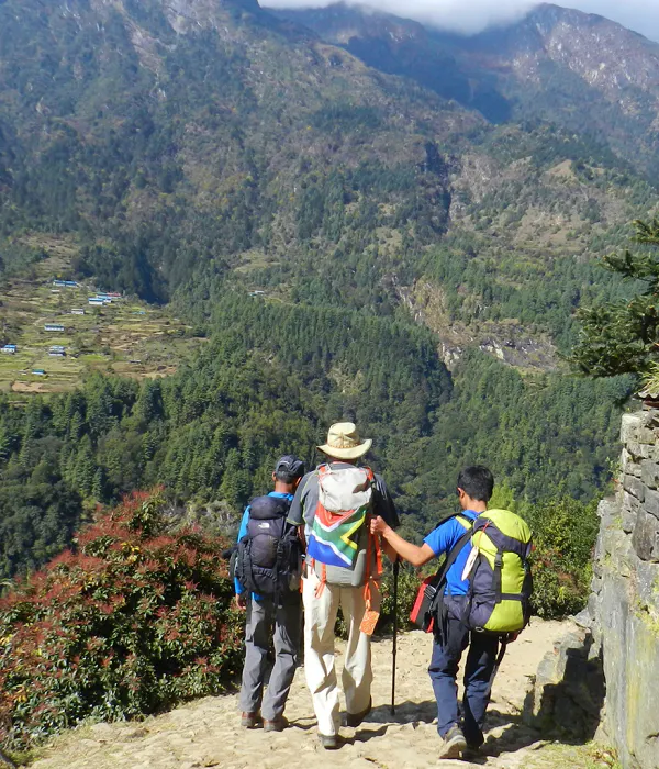 A group of people hiking up a mountain trail.