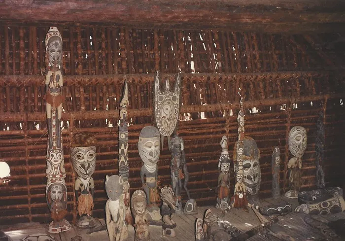 A group of wooden carvings in a hut.