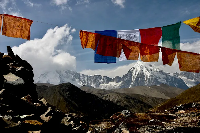Prayer flags with mountains in the background.