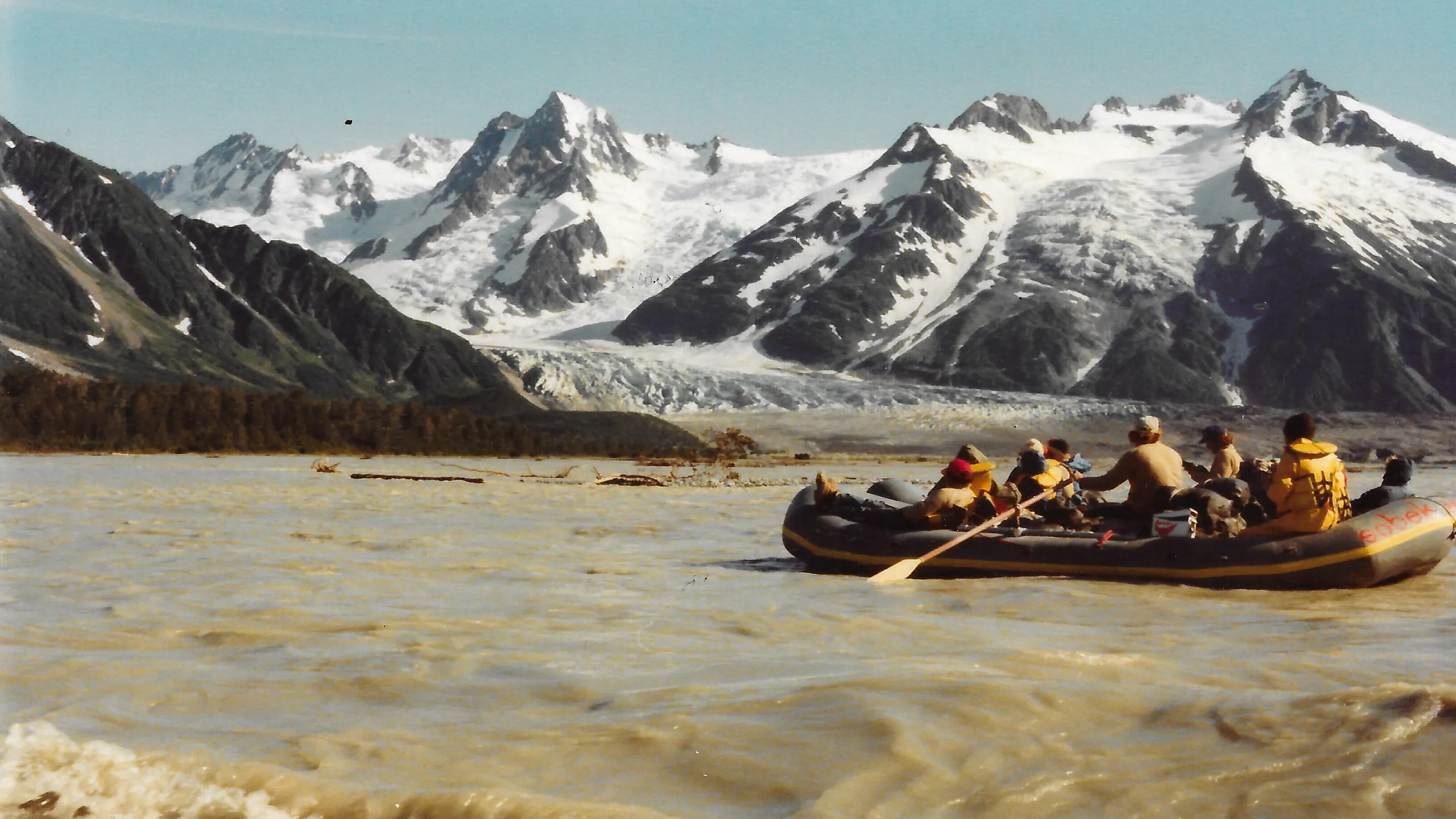 A group of people in a raft on a river.