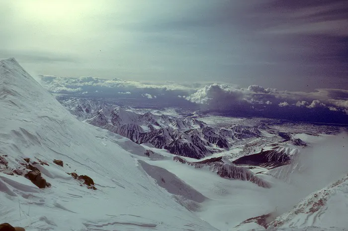 The view from the top of a snow covered mountain.