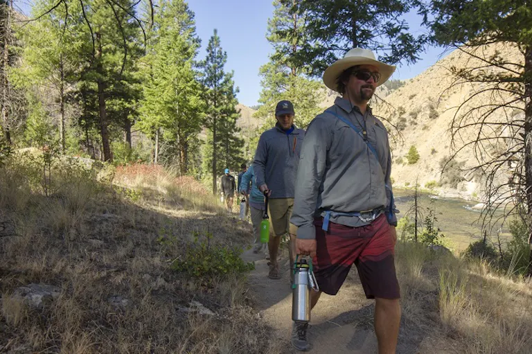group of hikers on hiking trail on a riverside hike near the Middle Fork of the Salmon River in Idaho, North America