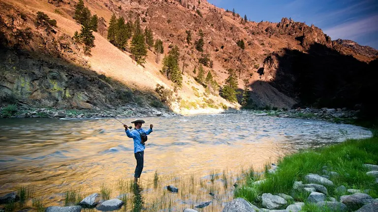 woman going fly fishing at Middle Fork of the Salmon River in Idaho, North America