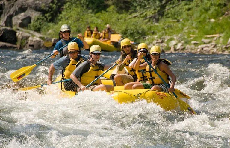 group of rafters on a guided rafting tour in whitewater rapids in Idaho