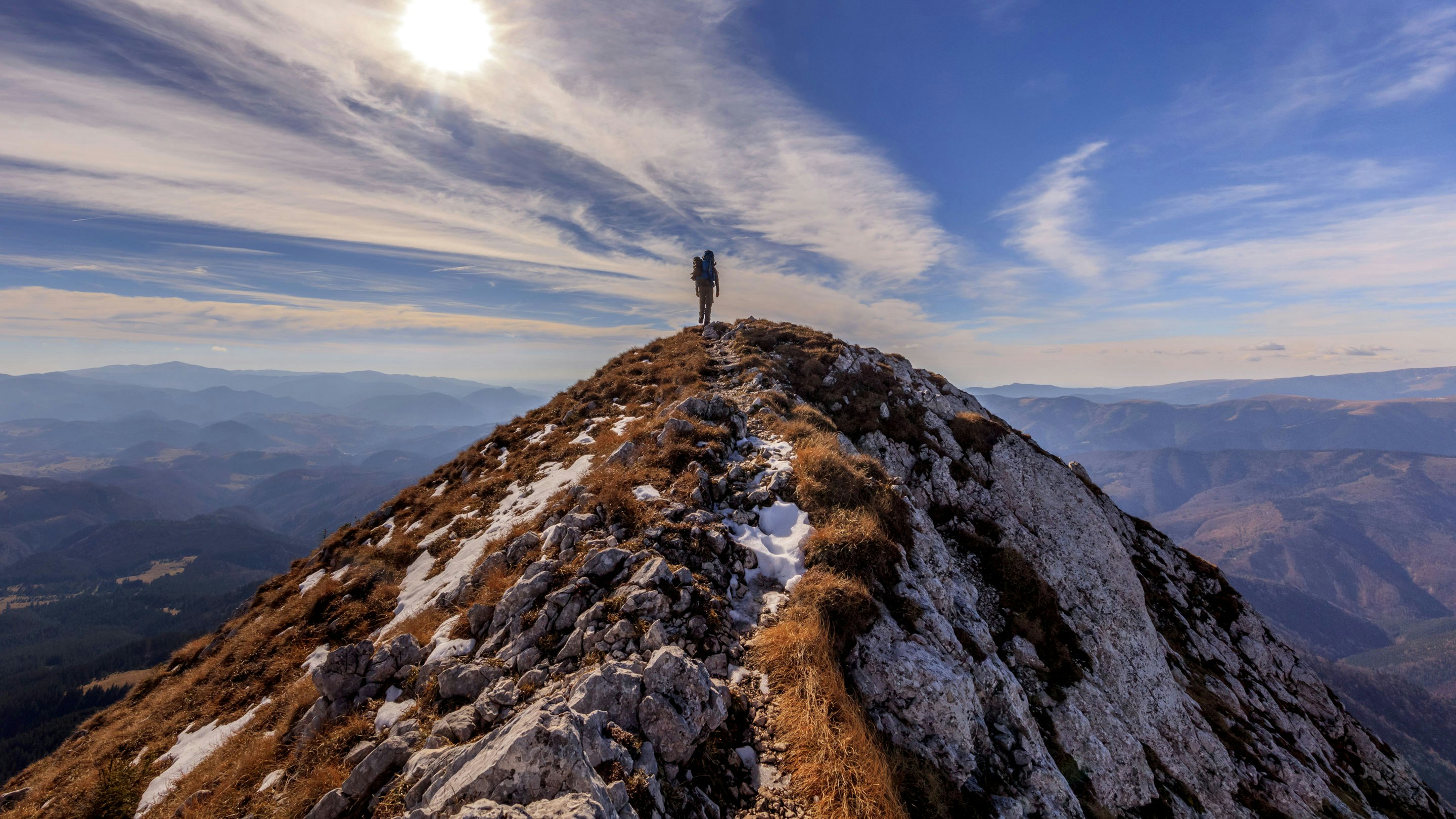 A person standing on top of a mountain.