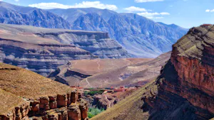 A view of a canyon with mountains in the background.